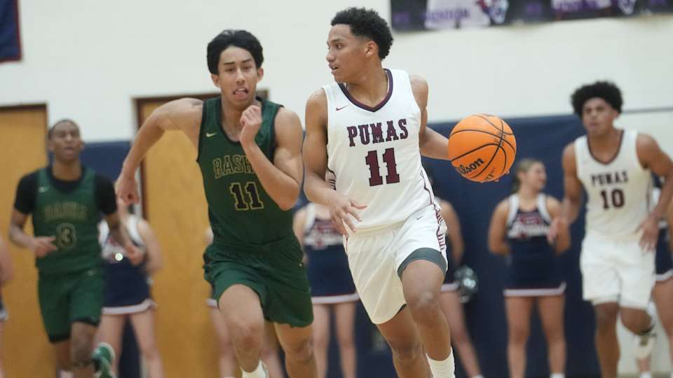 Arizona high school basketball: Perry Pumas guard No No Brown (11) brings the ball upcourt against the Basha Bears at Perry High School.